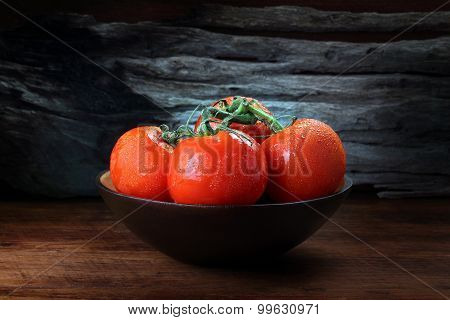 Cool Fresh Tomatoes In Black Bowl With Wooden Background