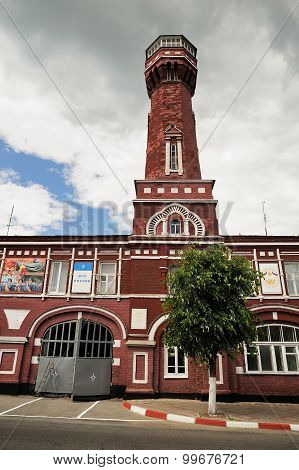 Elets, Russia - June 12, 2015: Day of Russia, Old Brick Fire Tower With Tree In Yelets, Russia