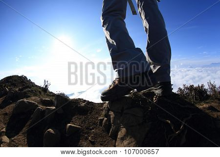 hiker legs on sunset mountain peak enjoy the view