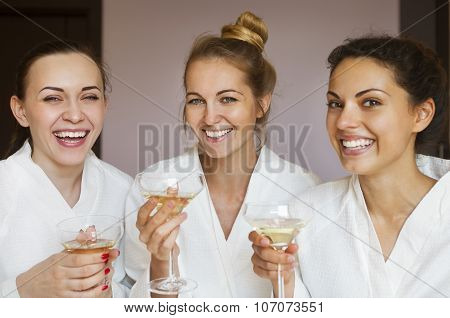 Young Happy Female Friends Drinking Champagne In Spa