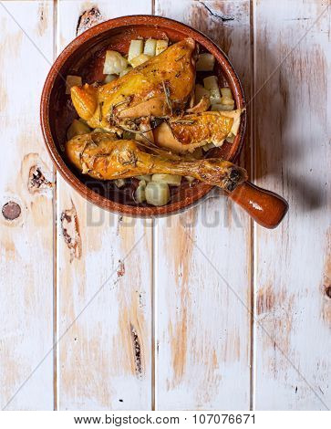 Grilled Chicken With Potatoes In A Rustic Bowl. Typical Spanish Tapa.