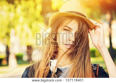 Beautiful teenage girl with hat in park