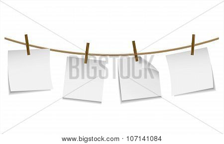 Blank white paper hanging on clothesline with clothespin