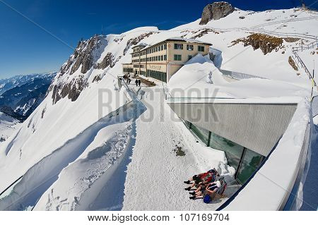 People sunbathe at the terrace of the Pilatus-Kulm luxury hotel at the top of the Pilatus mountain i