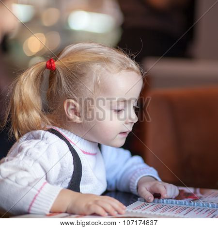 Little Girl Choosing Foood From Menu