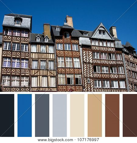 The half-timbered buildings of historic Rennes, Brittany, Northern France, against clear blue sky. In a colour palette with complimentary colour swatches.