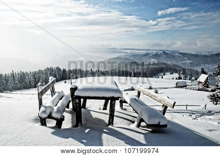 Table And Bench Covered By Fresh Snow After Blizzard