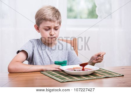 Child Eating Soup With Disgust