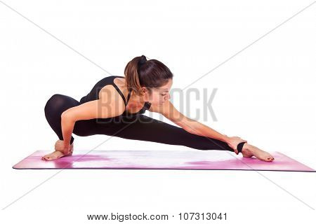 Beautiful woman doing Skandasana pose on yoga class, Studio shot.