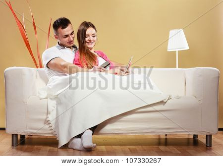 Young Couple With Tablet And Credit Card At Home