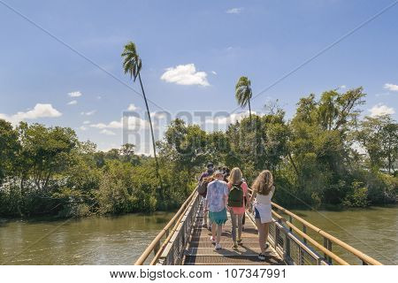 Tourists crossing the bridge which goes to devil throat falls