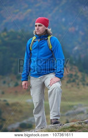 advanture man with backpack hiking on mountain forest