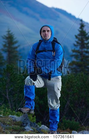 advanture man with backpack hiking on mountain forest