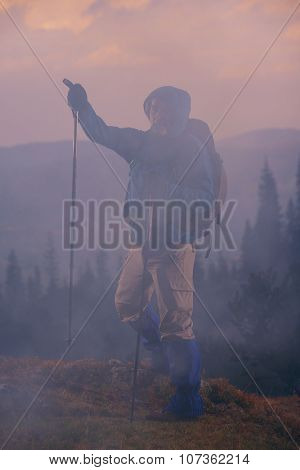 advanture man with backpack hiking on mountain forest