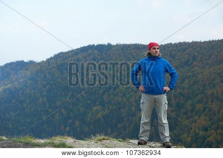 advanture man with backpack hiking on mountain forest