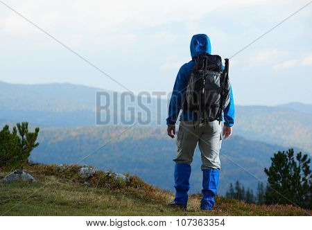 advanture man with backpack hiking on mountain forest