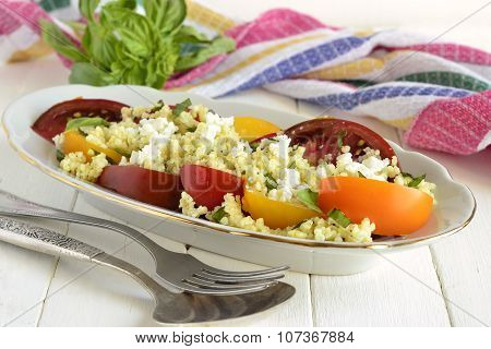 Millet with basil and fresh tomatoes and goat cheese