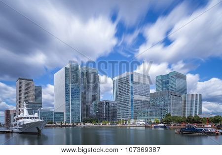 Skyscrapers of Canary Wharf with moving clouds in color, London, UK