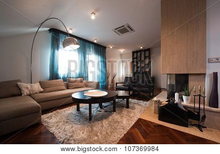 Loft Interior With Fireplace In The Middle Of The Room
