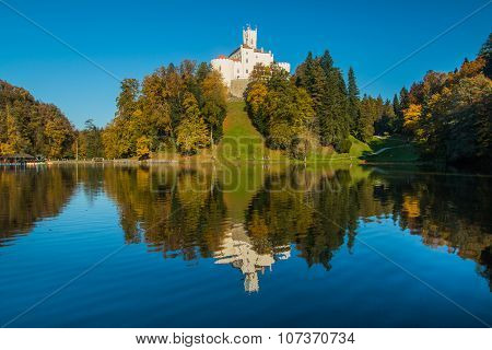 Castle of Trakoscan on the hill in autumn, Zagorje, Croatia, reflection on the lake