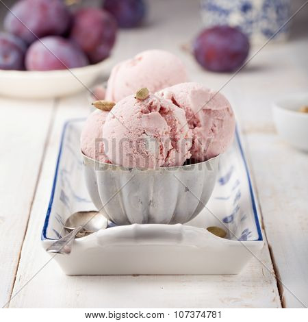 Plum ice cream with cardamon seeds. White background.