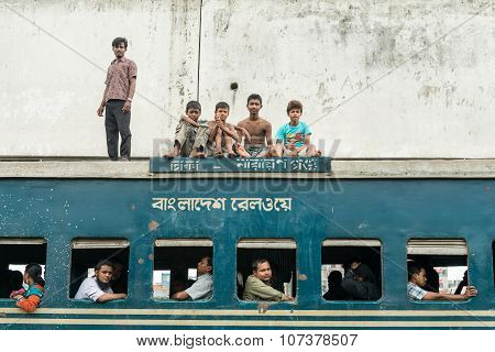 Commuters In Train Looking Through Window