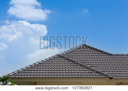 Black Tile Roof Of House With Blue Sky And Cloud Background