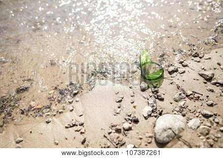 Broken Bottle Of Sharp Edged Lying On The Riverbank