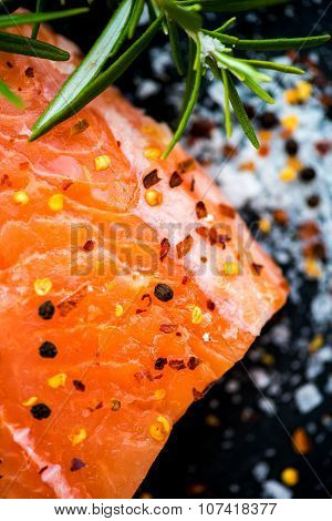 Portions Of Fresh Raw Salmon Fillets With Aromatic Herbs And Olive Oil