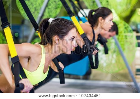 People at gym doing elastic rope exercises Concept sport workout fitness healthy lifestyle