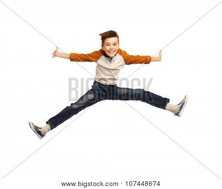 happiness, childhood, freedom, movement and people concept - happy smiling boy jumping in air