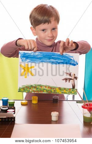The Boy Drew A Water Color On A Paper A Brush