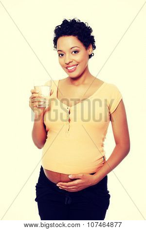 Pregnant woman with glass of water.