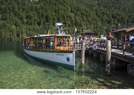 KOENIGSSEE, GERMANY - AUGUST 13, 2015: Pleasure boat at the landing stage of St. Bartholomew where the famous church is located
