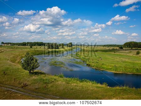 Summer Landscape With A River On Background Sky