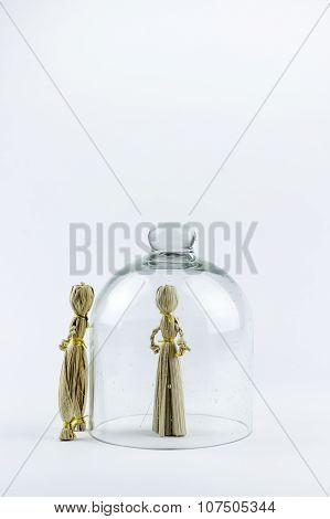 Man And Woman Straw Dolls, Separated By A Glass Bell