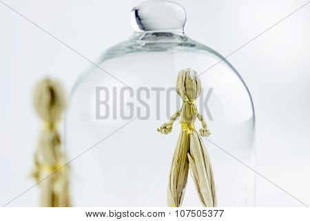 Man And Woman Straw Dolls, Separated By A Glass Bell