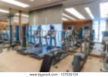 Abstract blur Fitness center with traineger equipments