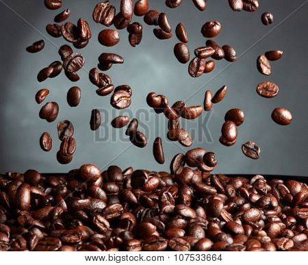 Flying coffee beans over dark background