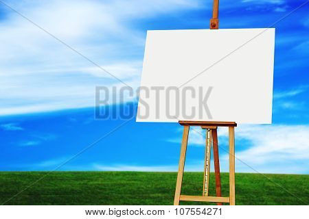 Easel With Blank Art Canvas In Grassland