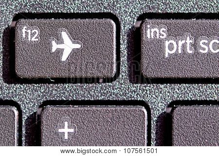with plane sign on keyboard