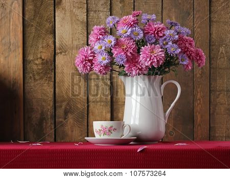 Still Life With A Bouquet Of Autumn Flowers And A Retro A Cup.