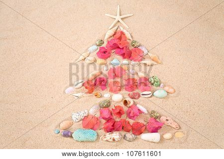 Beach Xmas Concept, Christmas Tree  On Sand Made Out Of Sea Shelles And Flower Pettal