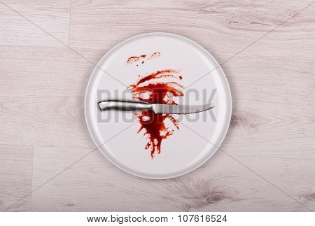 Knife On White Plate With Blood