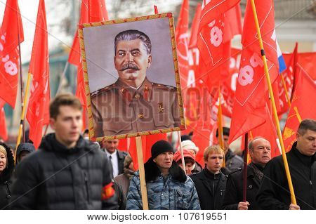 Orel, Russia - November 7, 2015: Communist Party Meeting. Stalin Portrait, Red Flags, People Marchin