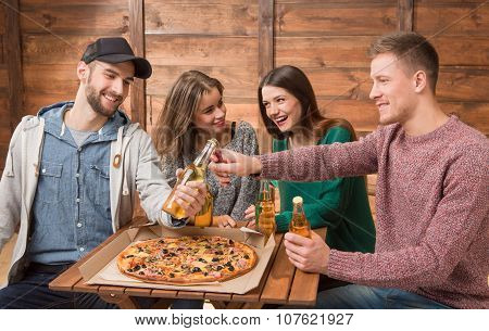 Happy friends resting in pizzeria