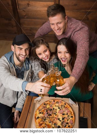 Happy friends resting with alcohol drinks in pizzeria