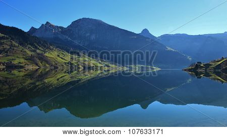 Beautiful Shaped Mountains Mirroring In Lake Wagital