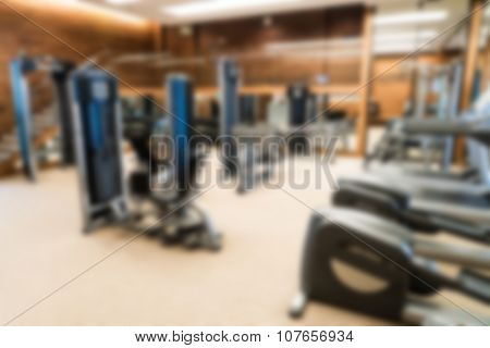 Abstract blur Fitness center with traineger equipments