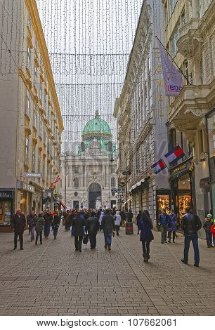 VIENNA AUSTRIA JANUARY 8 2014: Kohlmarkt street with Hofburg Complex in downtown of Vienna in Austria with Christmas decoration in the street